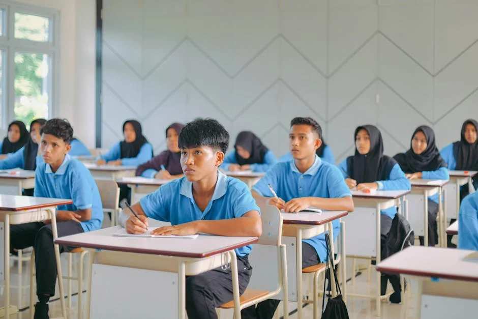 High school students in uniform attentively studying in an Indonesian classroom. - learning school students - Early childhood education