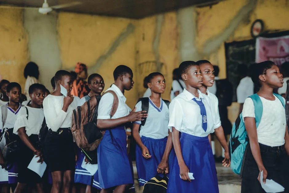 Group of African high school girls in uniform during class transition indoors. - learning school students - Early childhood education