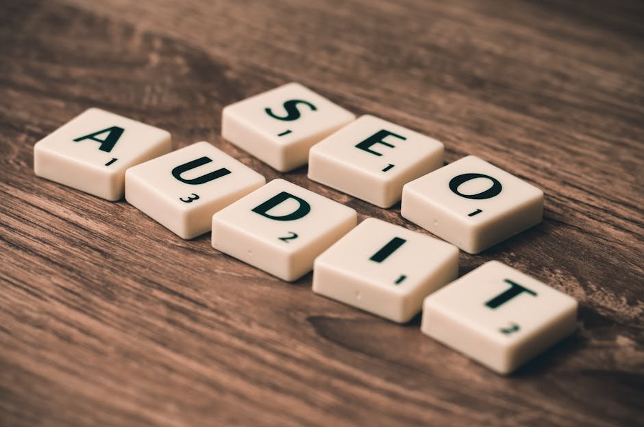 Scrabble tiles spelling SEO Audit on wooden surface, symbolizing digital marketing strategies. - search engine optimization - Google SEO