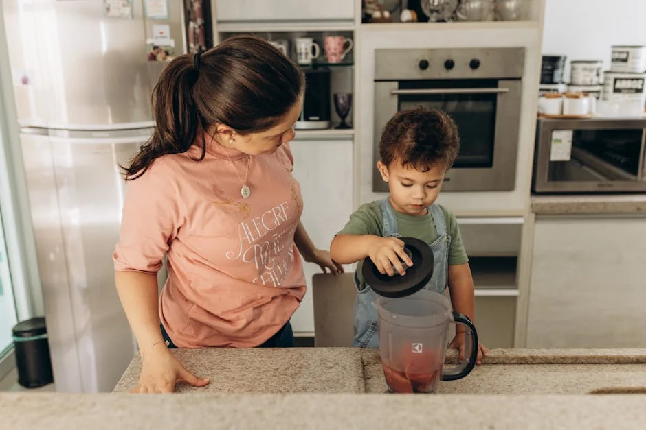 Mother and son bonding while preparing a smoothie in the kitchen. - parentchild communication