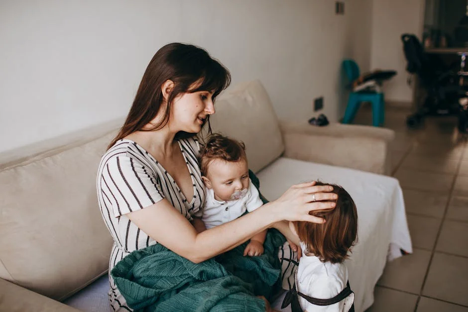 A mother lovingly cares for her two young children in a cozy home environment, creating a warm family moment. - family children care - Parenting tips