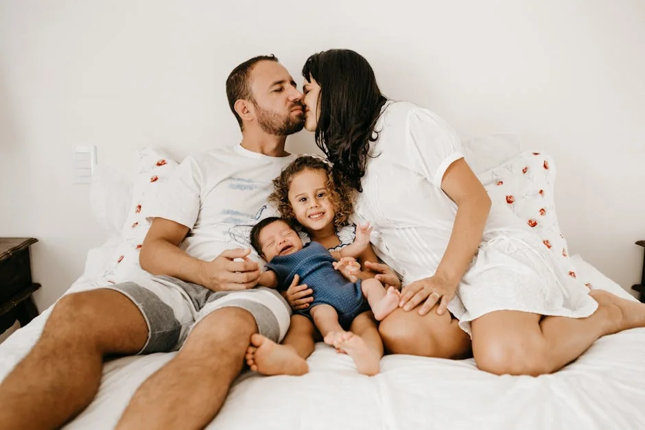 Happy family relaxing and enjoying quality time on a cozy bed, expressing love and togetherness. - family children care - Parenting tips