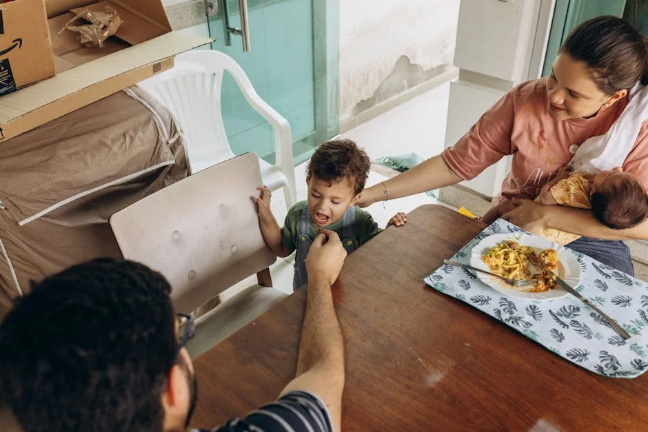A family enjoys a meal together at a dining table, depicting a warm and intimate family moment. - family children care - Parenting tips