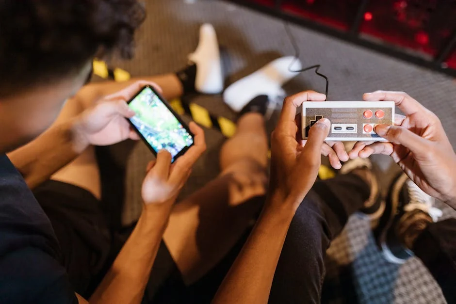 Close-up of teenagers playing mobile and retro video games indoors, showcasing fun and technology. - pubg mobile gameplay